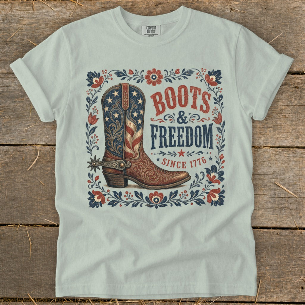 Light blue t-shirt with a patriotic boot design, text "BOOTS & FREEDOM SINCE 1776".
