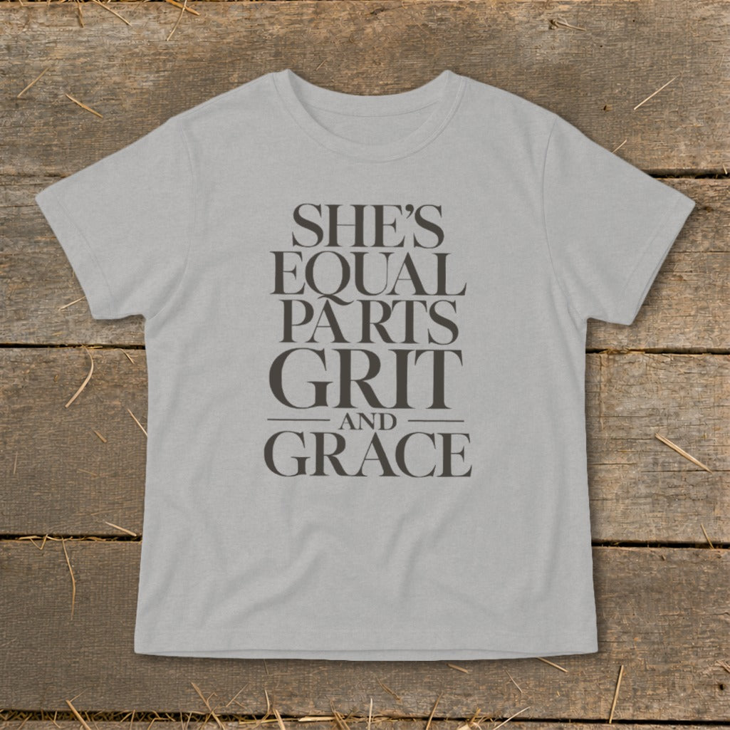 Light gray t-shirt with "She's Equal Parts Grit and Grace" text in dark gray.