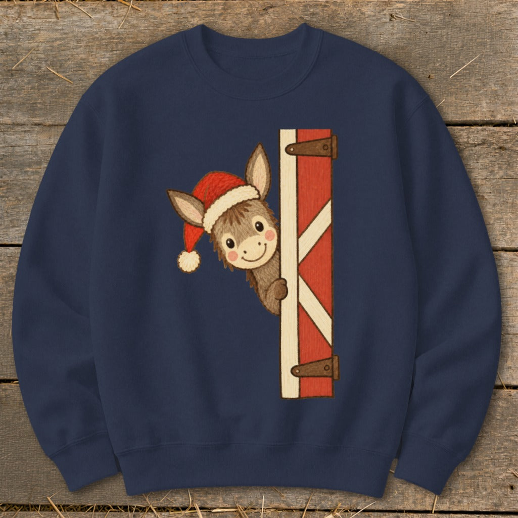 Navy sweatshirt with a smiling donkey wearing a Santa hat peeking from behind a red barn door.
