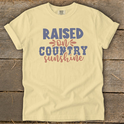 Yellow t-shirt with "RAISED ON COUNTRY SUNSHINE" text.
