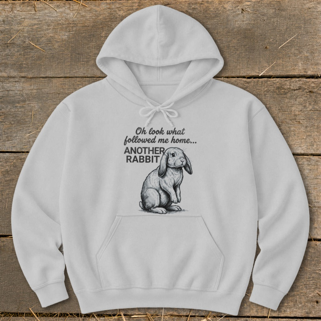 White hoodie with rabbit graphic and text "Oh look what followed me home... ANOTHER RABBIT".