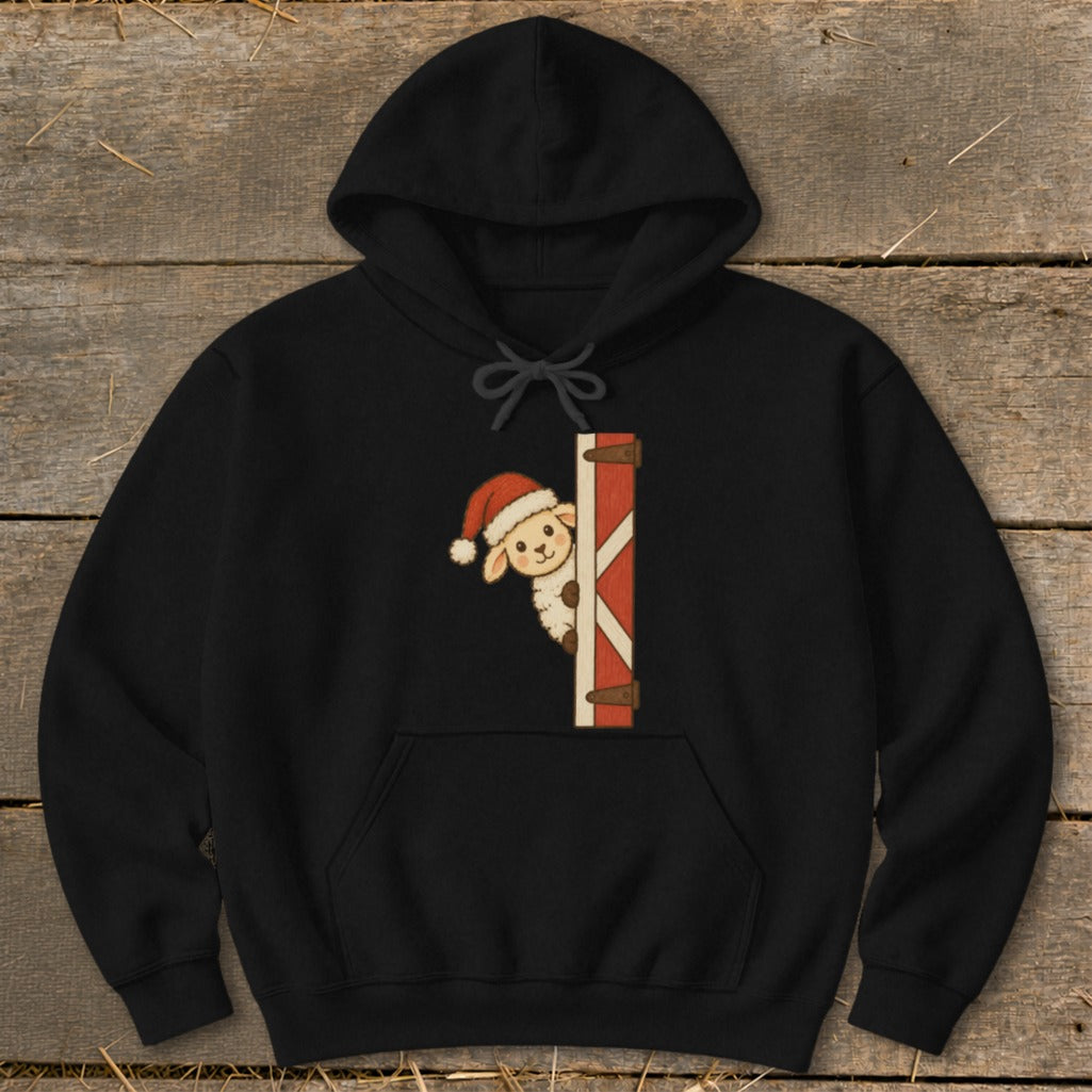 Black hoodie featuring a cute lamb in a Santa hat peeking from behind a barn door.