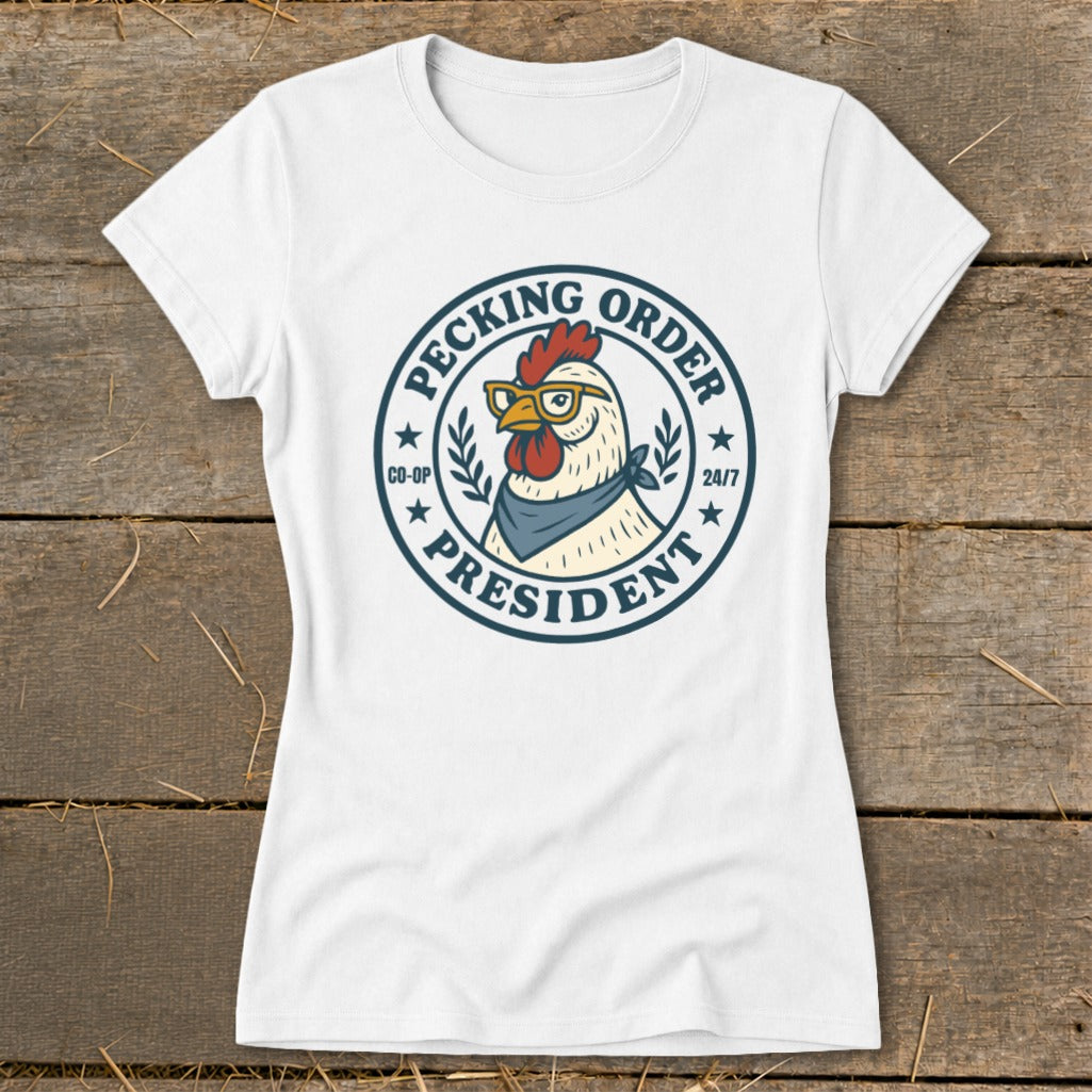 White t-shirt with a round graphic of a chicken wearing glasses and a bandana, reading "Pecking Order President".