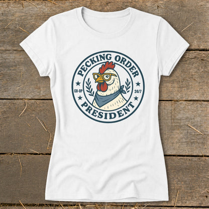 White t-shirt with a round graphic of a chicken wearing glasses and a bandana, reading "Pecking Order President".