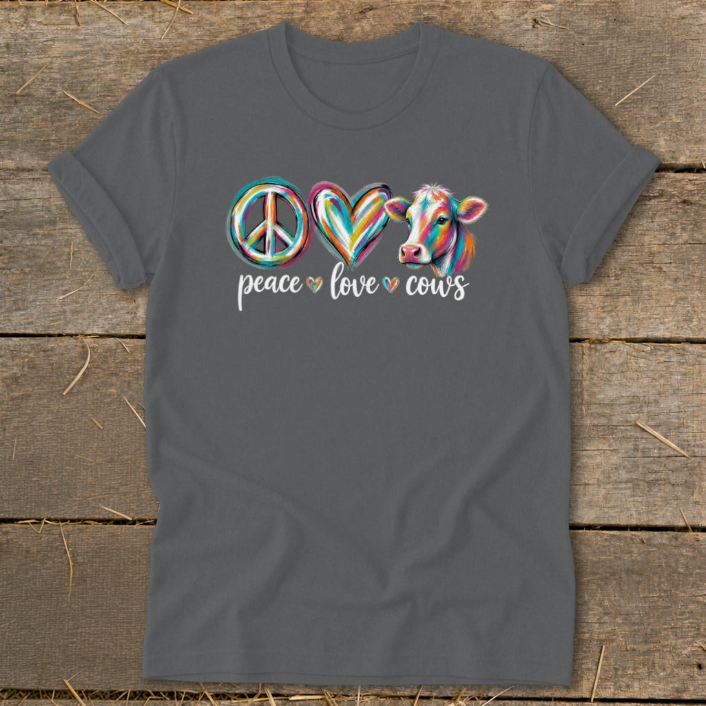 T-shirt with peace, heart, and colorful cow graphics and text "peace love cows".