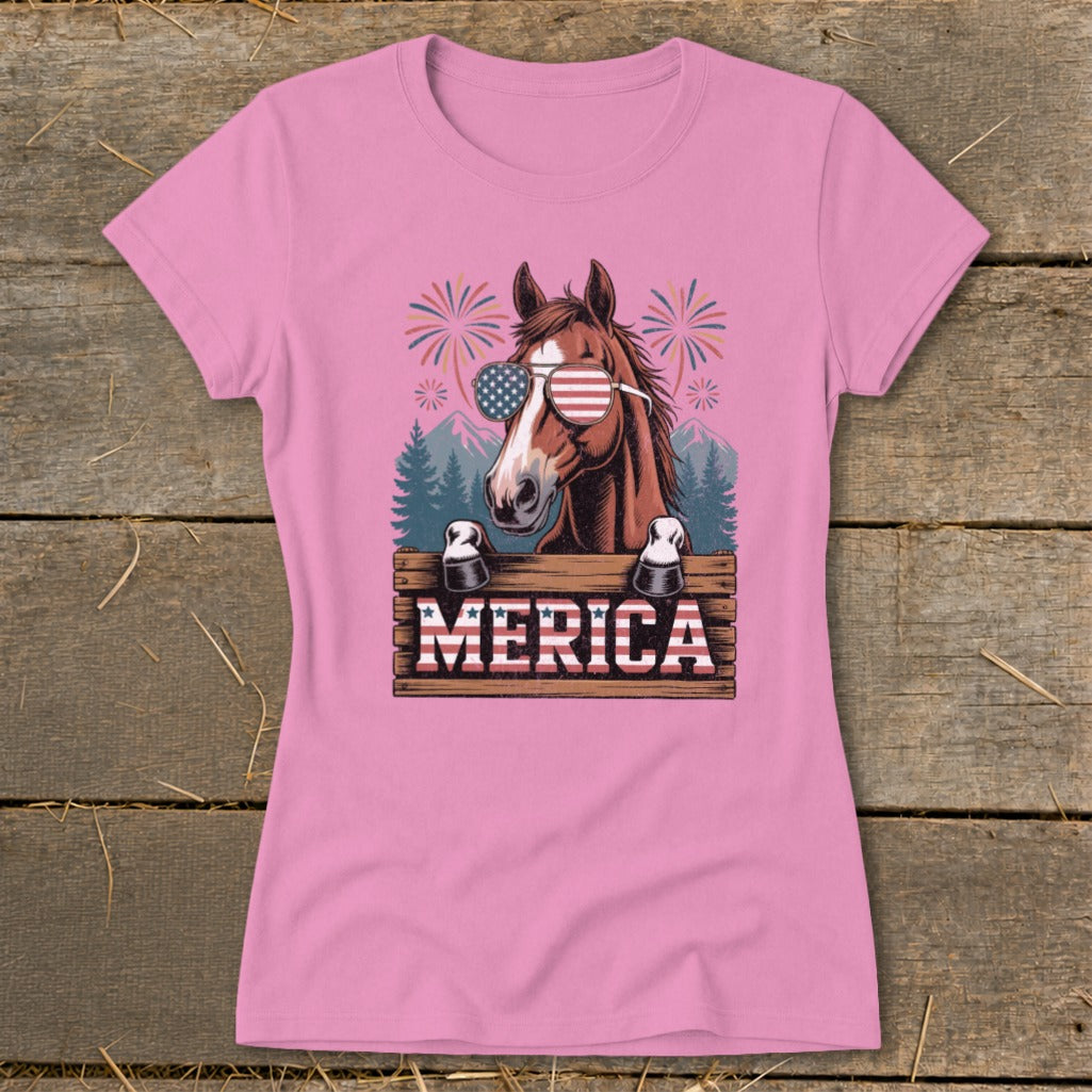 Horse wearing American flag sunglasses on "MERICA" sign with fireworks.