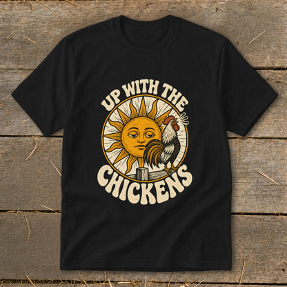 A black t-shirt features a vintage-style graphic of a rooster crowing before a sun with the text UP WITH THE CHICKENS.