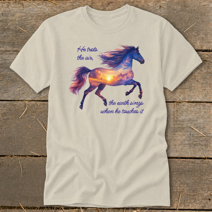 A light beige t-shirt displays a running horse graphic with a sunset sky silhouette and cursive text.