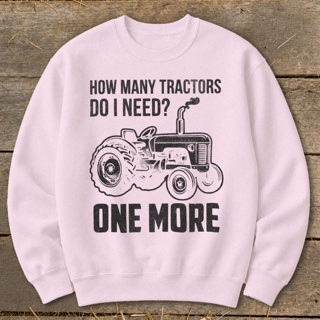Pink sweatshirt with "How Many Tractors Do I Need? One More" and tractor graphic.