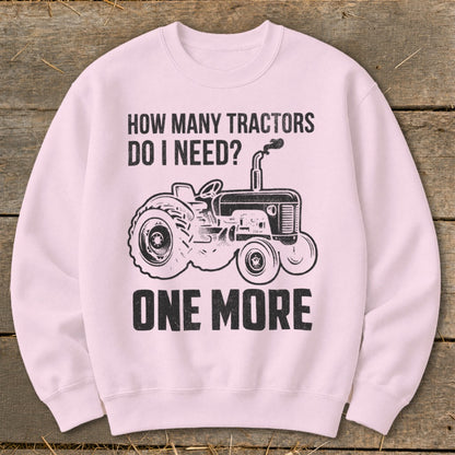 Pink sweatshirt with "How Many Tractors Do I Need? One More" and tractor graphic.