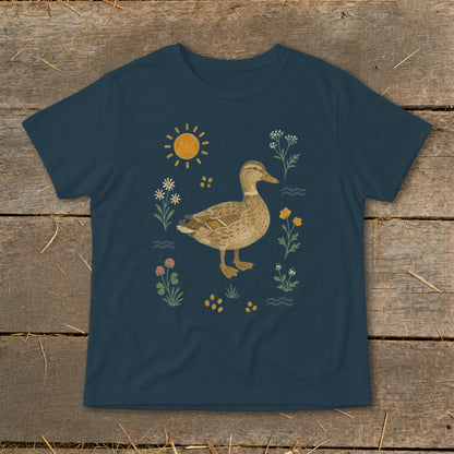 Navy t-shirt with a duck illustration surrounded by flowers, sun, and water.