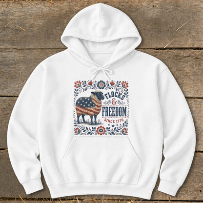 White hoodie with American flag sheep graphic, "Flocks & Freedom Since 1776".