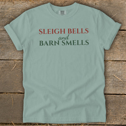 Light blue t-shirt with red and green text reading "Sleigh Bells and Barn Smells".