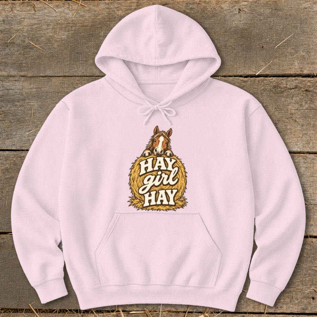 Pink hoodie with a horse on a hay bale graphic that says "HAY girl HAY".