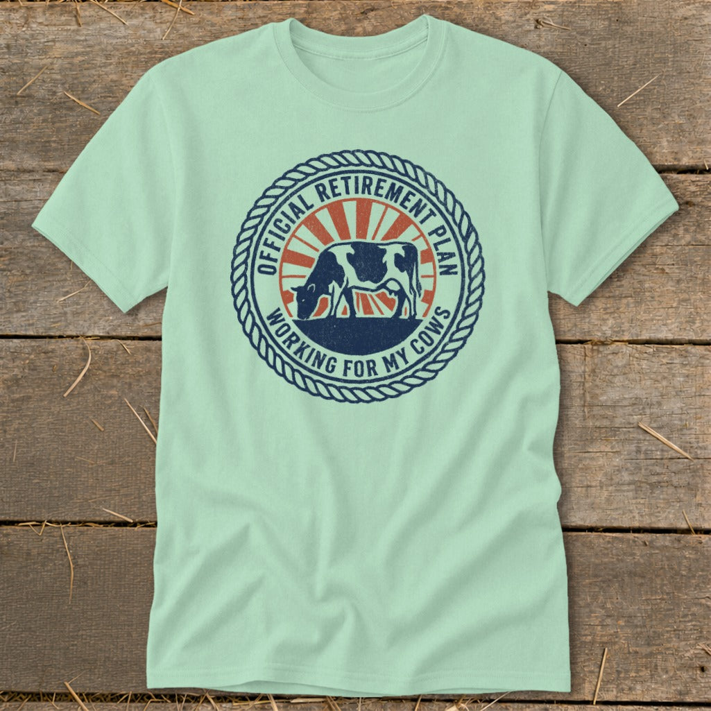 Mint t-shirt with circular graphic of a cow and "Official Retirement Plan Working For My Cows" text.