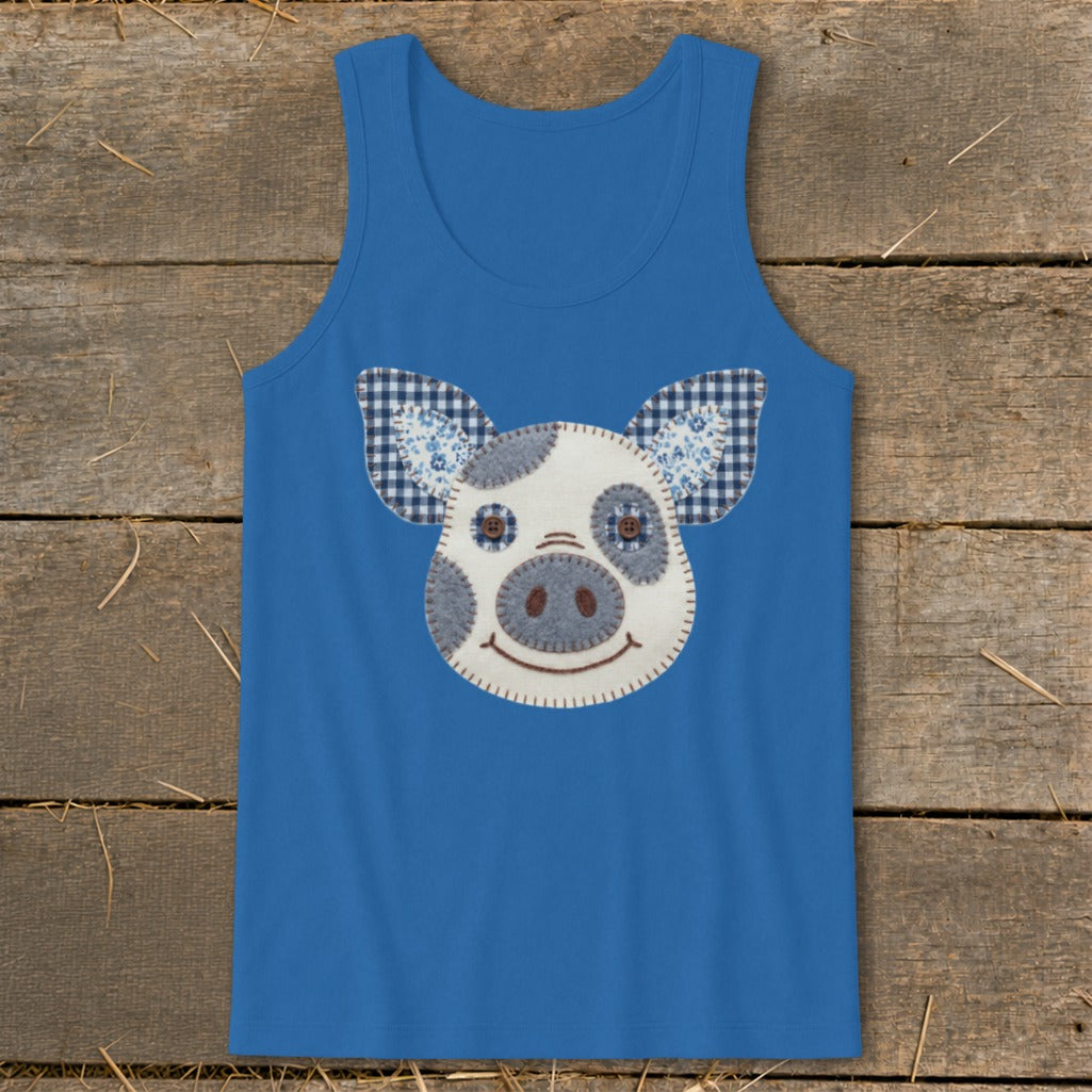 Blue tank top with a fabric appliqué of a smiling pig face with checkered ears.