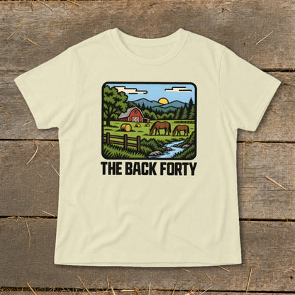 Cream-colored t-shirt featuring a cartoon rural farm landscape graphic and the text "The Back Forty".