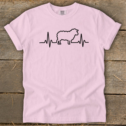 Light pink t-shirt featuring a black graphic of a sheep integrated into a heartbeat line.