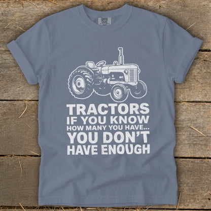 Shirt with white tractor graphic and text: "Tractors if you know how many you have... you don't have enough."