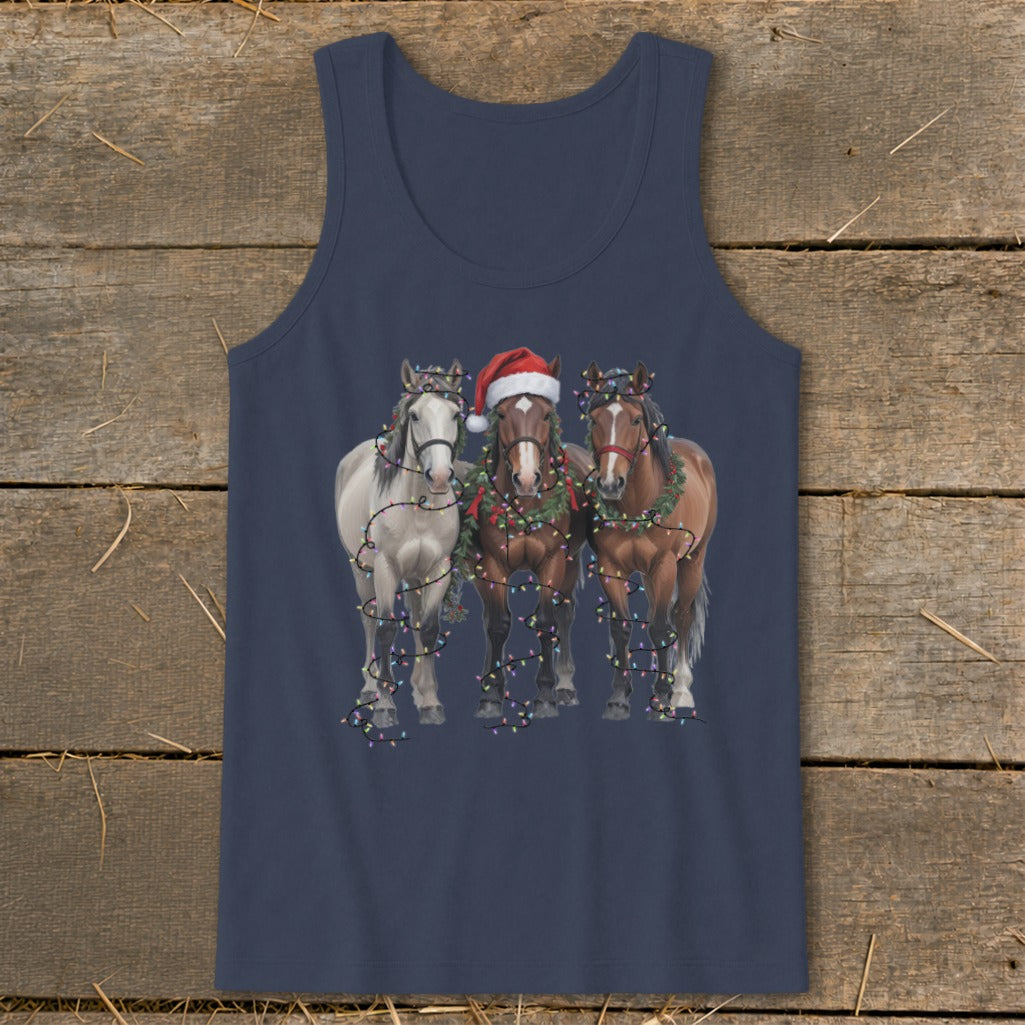 Three horses, one wearing Santa hat, are wrapped in Christmas lights.
