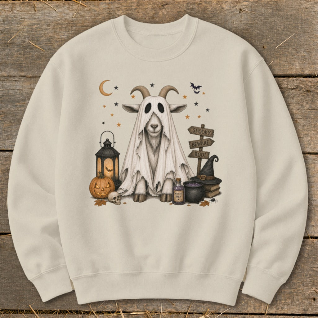 Cream sweatshirt with a Halloween graphic of a goat in a ghost costume with spooky decorations.