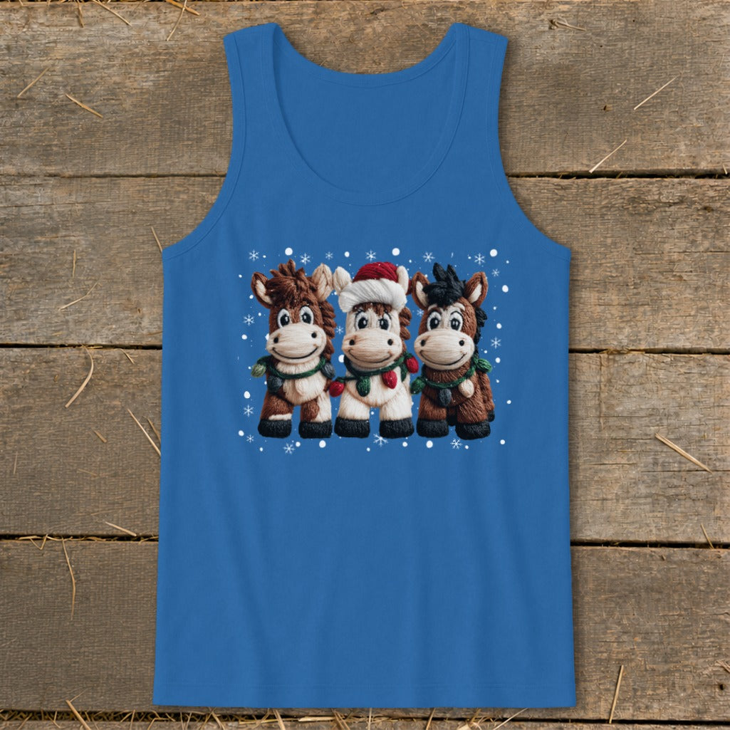 Three cartoon horses in festive attire, with snowflakes, on a blue tank top.