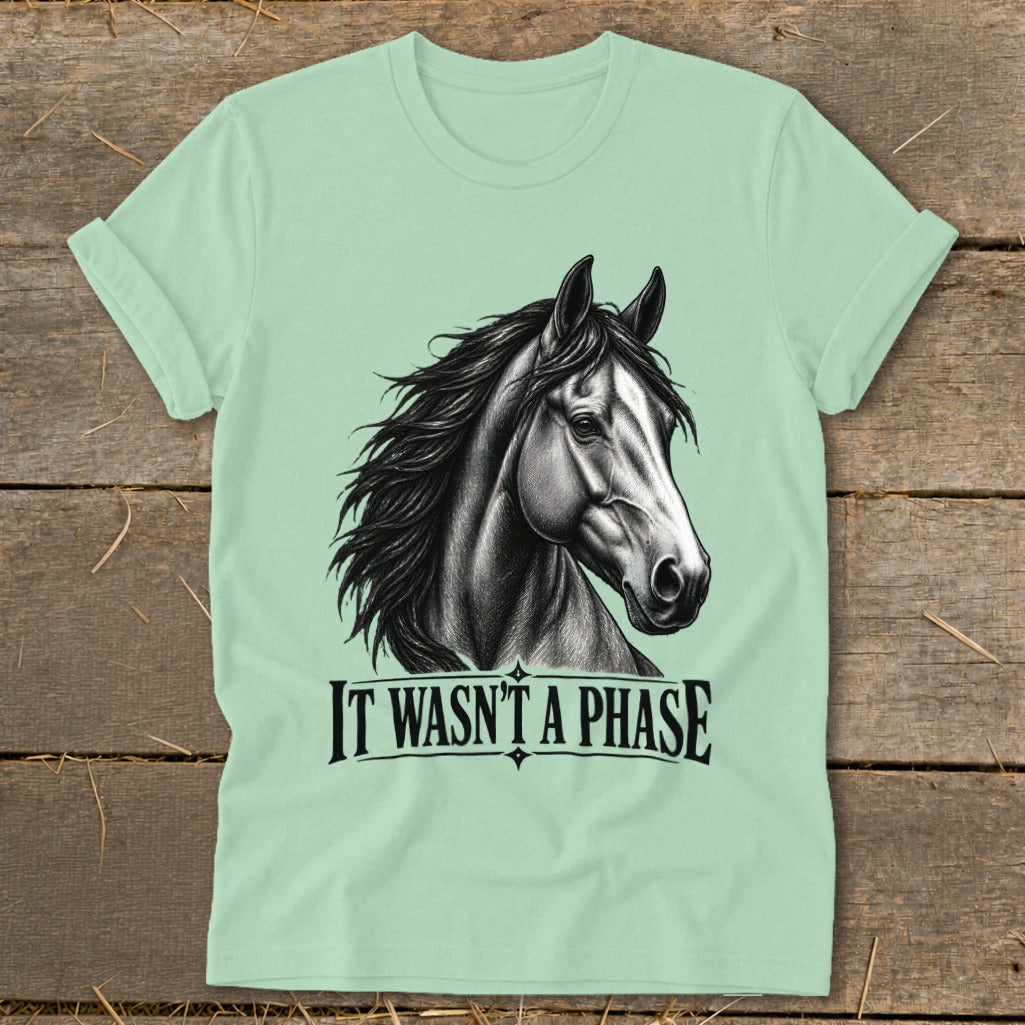 Light green t-shirt with black sketch of horse head and "IT WASN'T A PHASE" text.