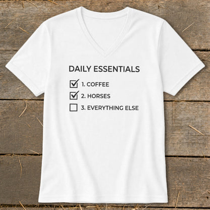 White v-neck t-shirt with "Daily Essentials" and a checklist of coffee, horses, and everything else.