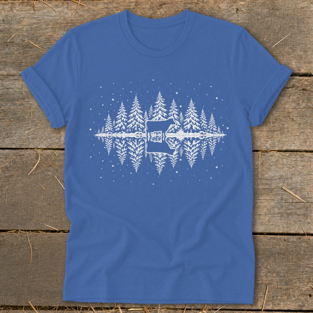 Blue t-shirt with white graphic of trees and a cow reflected in water.