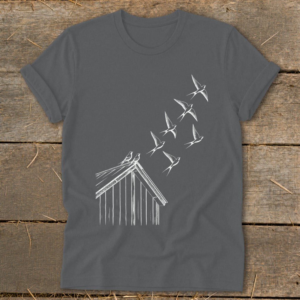 Dark gray t-shirt featuring a white line drawing of birds flying from a rooftop.