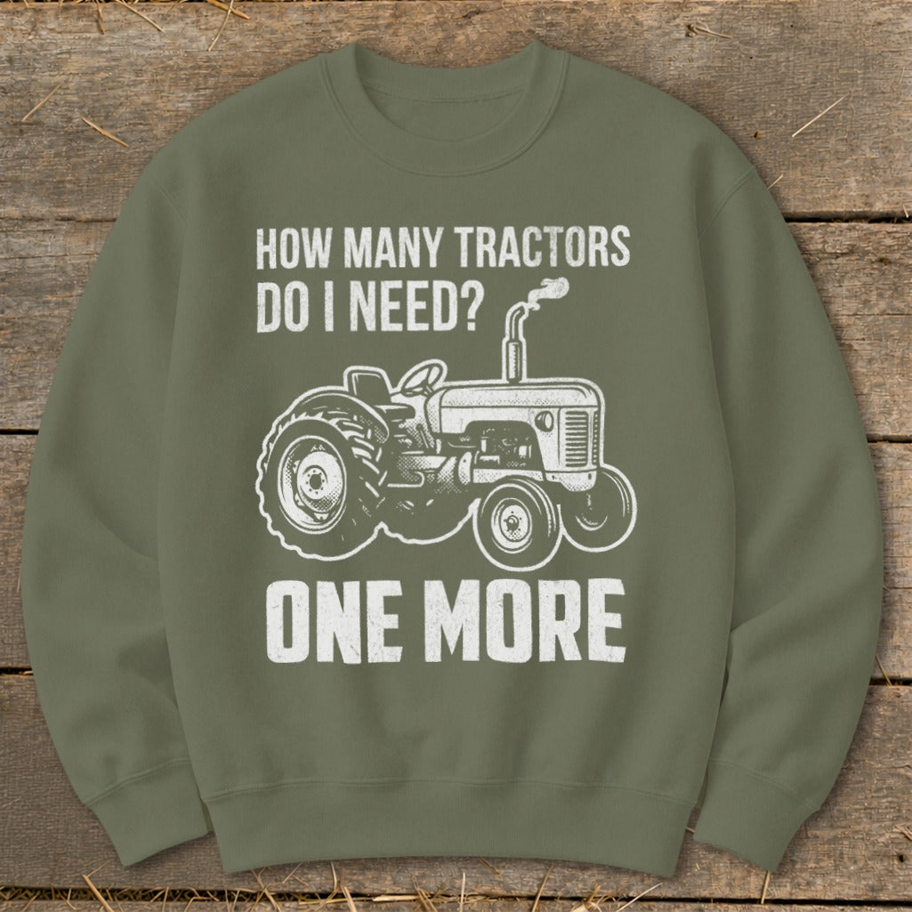 Green sweatshirt with white text and tractor graphic: "How Many Tractors Do I Need? One More"