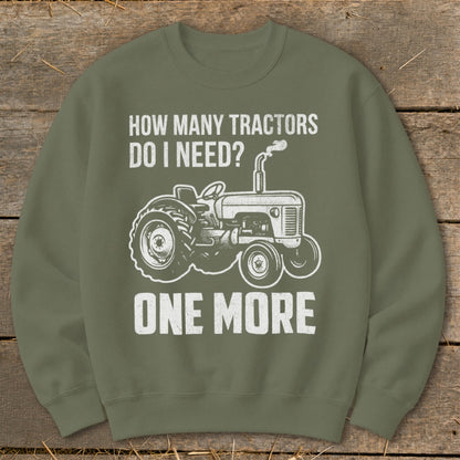 Green sweatshirt with white text and tractor graphic: "How Many Tractors Do I Need? One More"
