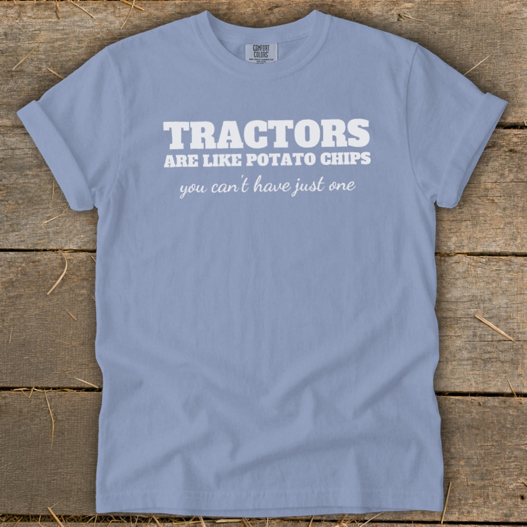 Light blue t-shirt with white text "Tractors are like potato chips you can't have just one".