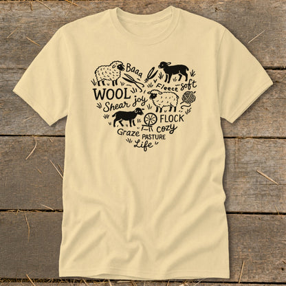 Cream t-shirt with black heart design featuring sheep, wool, fleece, and farm-related words.