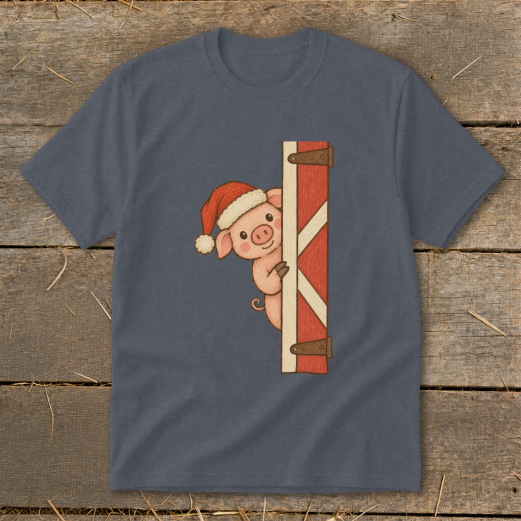 Pig wearing Santa hat peeking from behind a barn door graphic on a gray t-shirt.