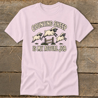 Pink t-shirt with "Counting Sheep Is My Actual Job" and three jumping sheep.