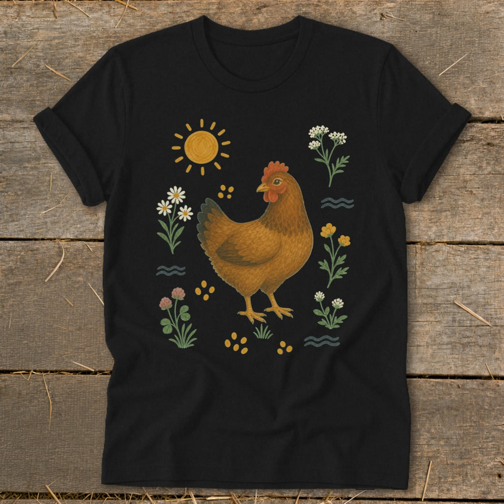 Black t-shirt with a brown hen surrounded by wildflowers, sun, and yellow dots.