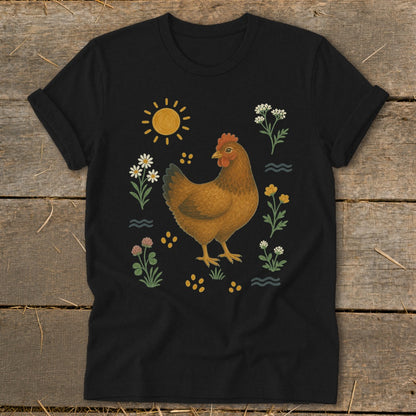 Black t-shirt with a brown hen surrounded by wildflowers, sun, and yellow dots.