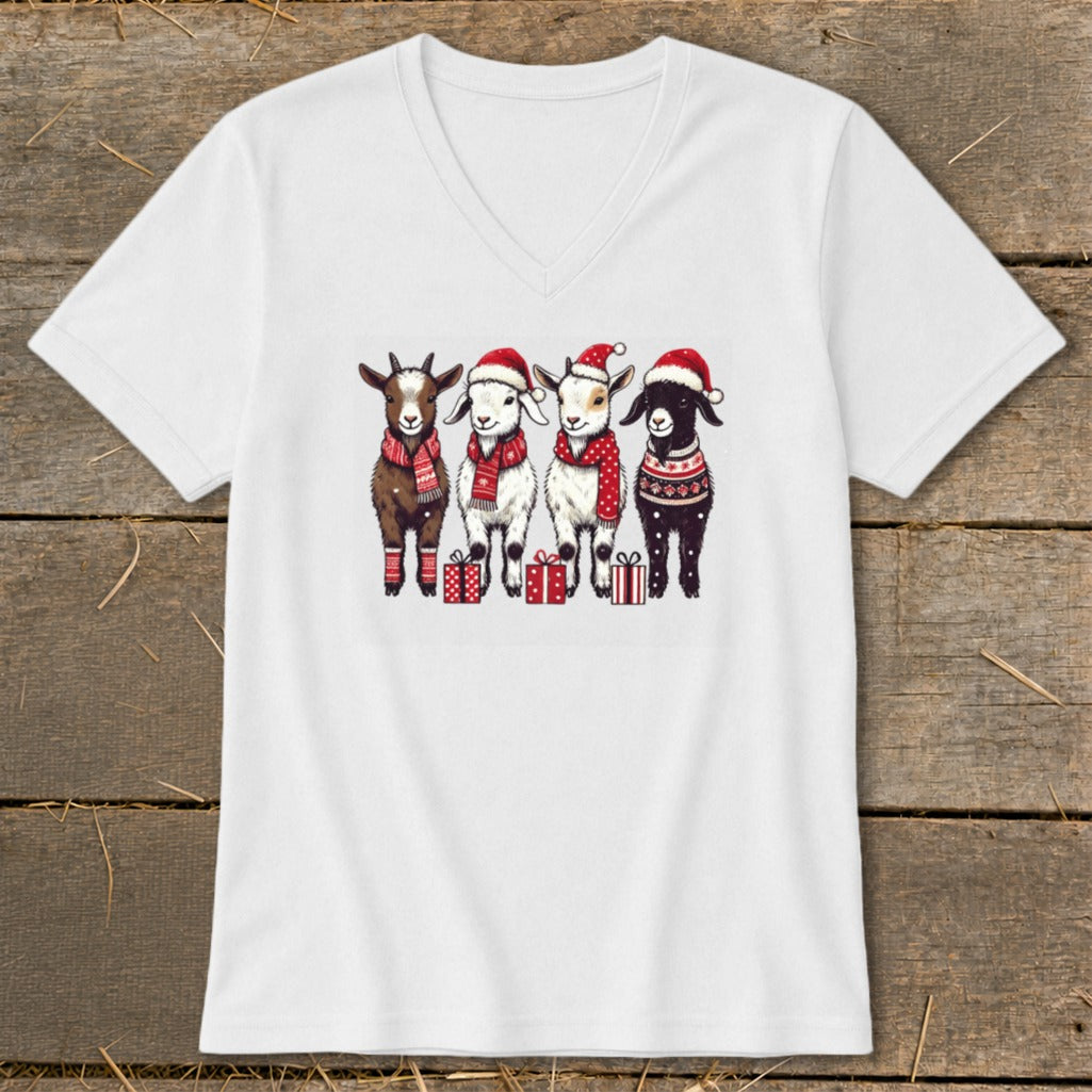 Four goats wearing Santa hats and scarves stand with presents.