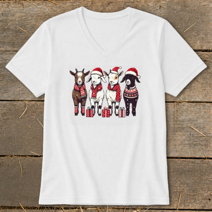 Four goats wearing Santa hats and scarves stand with presents.