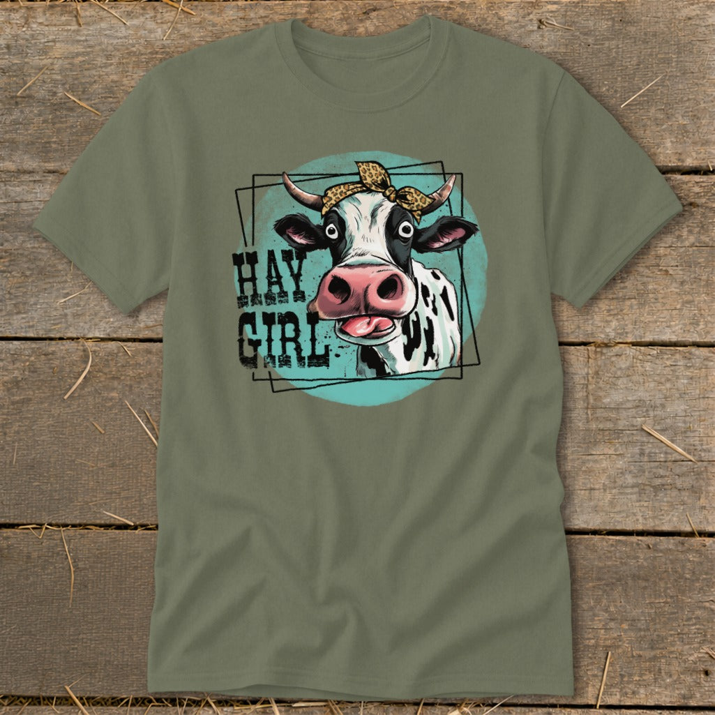 Cow with bandana and text "HAY GIRL" on a green t-shirt.