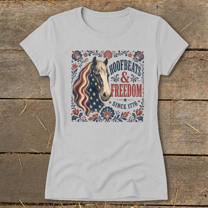 T-shirt with a horse wearing the American flag and "Hoofbeats & Freedom Since 1776" text.