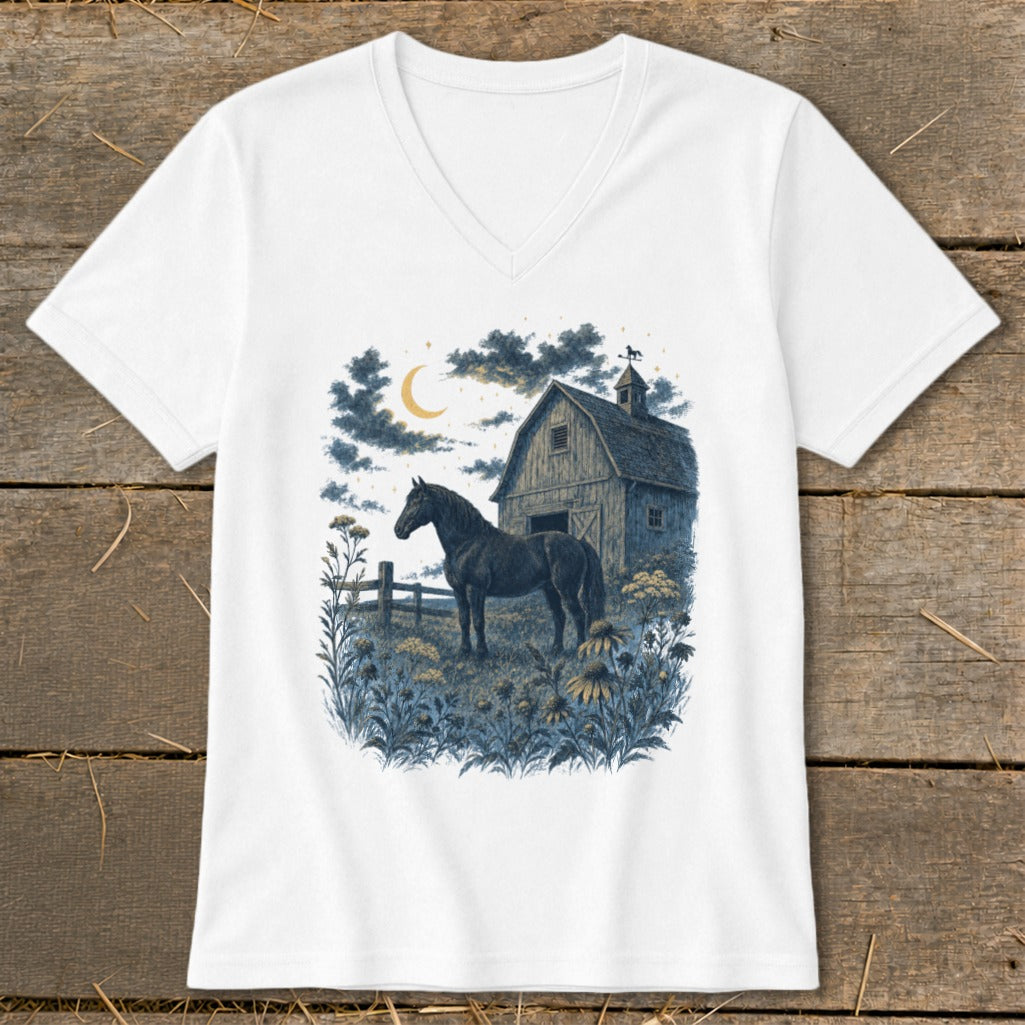 Dark horse stands in field with barn and moon at night.