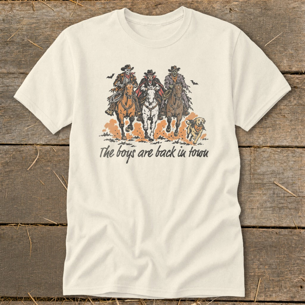 Cream t-shirt with graphic of three skeleton cowboys on horseback and running dog.