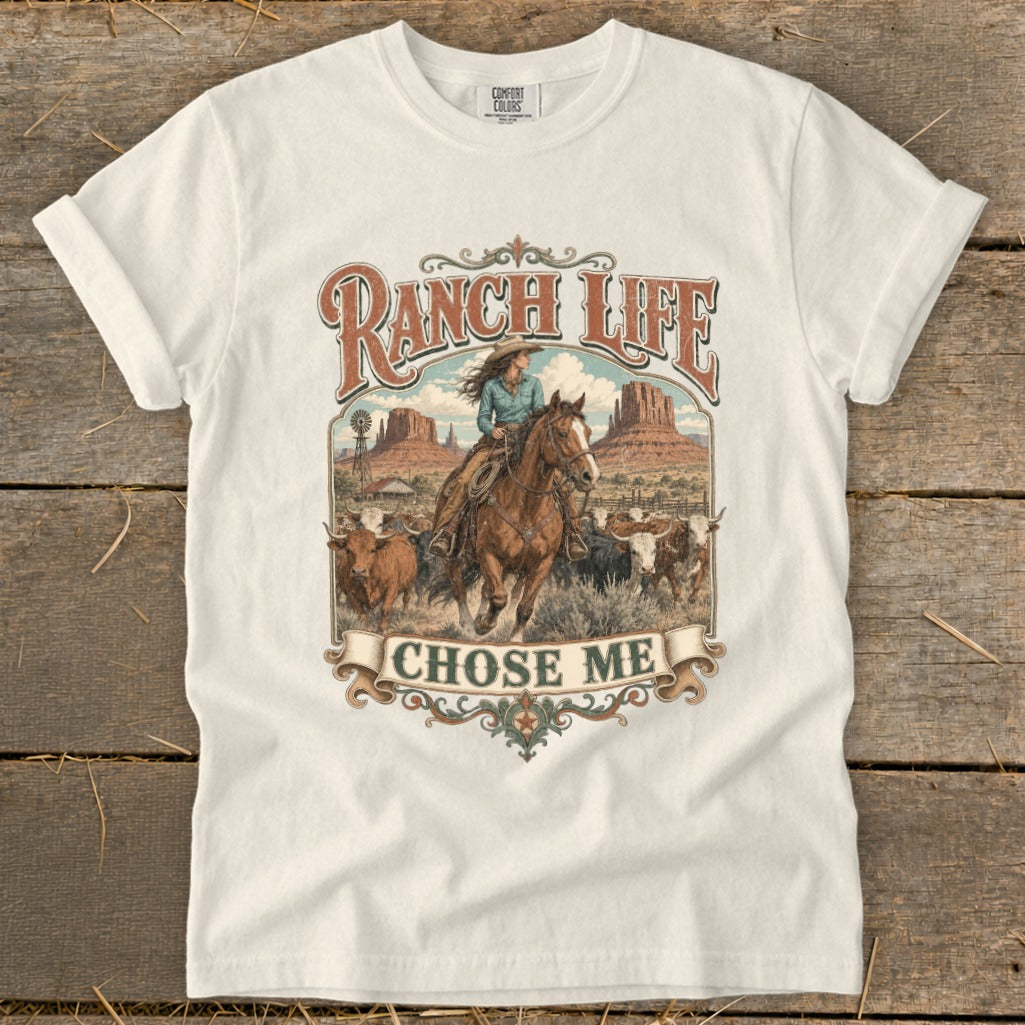 T-shirt with western graphic: woman on horse, cattle, windmill, mountains, and text "Ranch Life Chose Me".
