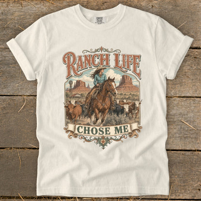 T-shirt with western graphic: woman on horse, cattle, windmill, mountains, and text "Ranch Life Chose Me".