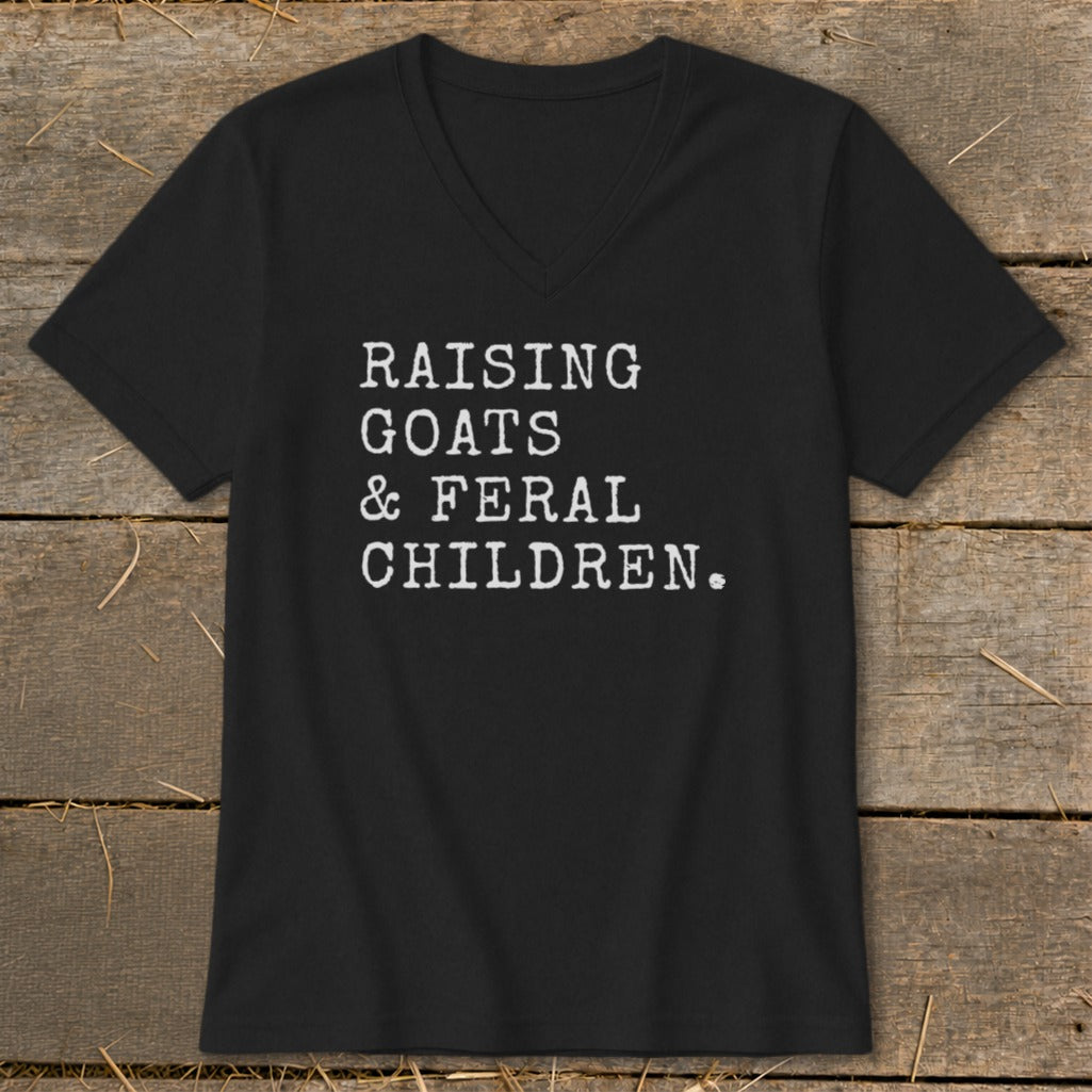 Black v-neck t-shirt with white text: "RAISING GOATS & FERAL CHILDREN."