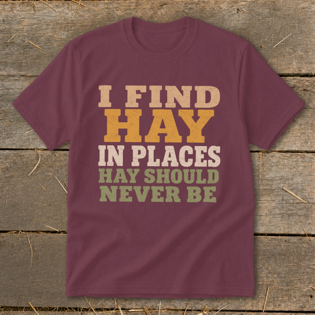 Maroon t-shirt with text "I FIND HAY IN PLACES HAY SHOULD NEVER BE".