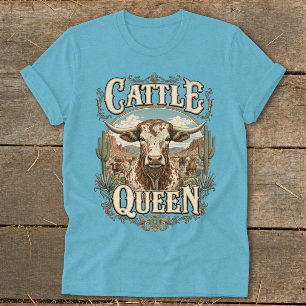 Turquoise t-shirt with "Cattle Queen" text and a longhorn cow in a desert landscape.