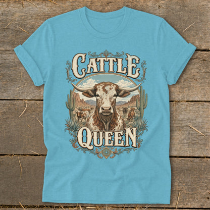 Turquoise t-shirt with "Cattle Queen" text and a longhorn cow in a desert landscape.